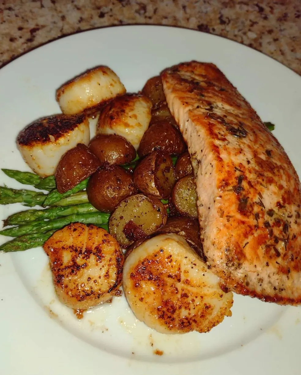 Salmon and seared scallops with potatoes and asparagus