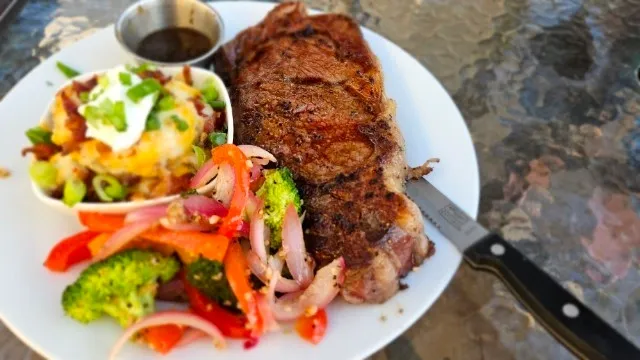 Ribeye with loaded potatoes and roasted vegetables