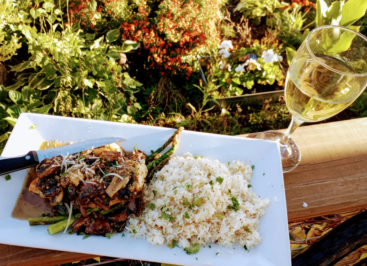 Mushroom chicken with rice and asparagus on the patio